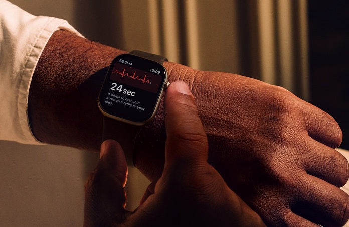 Osoba si podržením korunky Digital Crown na Apple Watch Series 11 měří zdraví srdce v aplikaci EKG