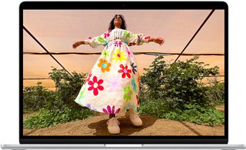 MacBook Air screen showing photo of person in colorful outfit, demonstrating color range and resolution of Liquid Retina display