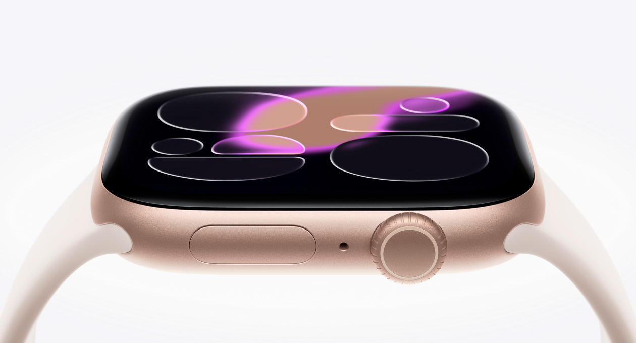 Apple Watch Series 11, rose gold color, aluminum case, Responsive Art watch face, right side exterior, Digital Crown, microphone, side button, Sport Band, light blush color